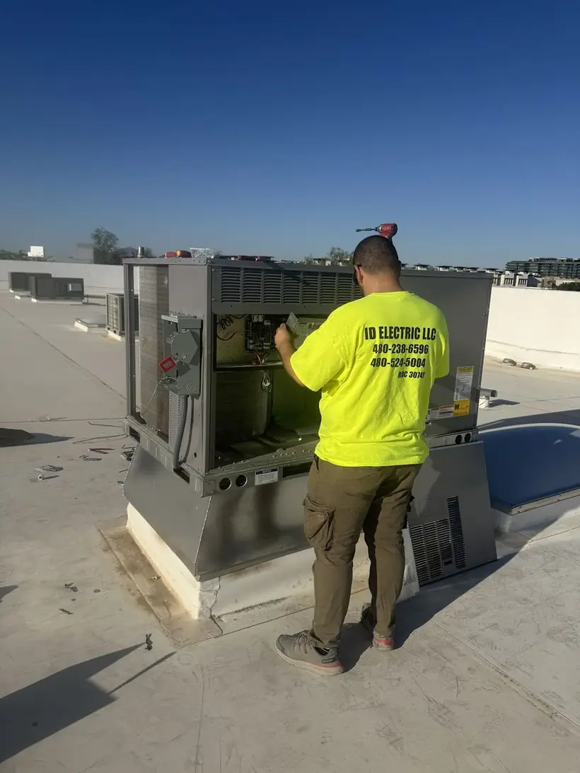 Electrician working on commercial rooftop equipment